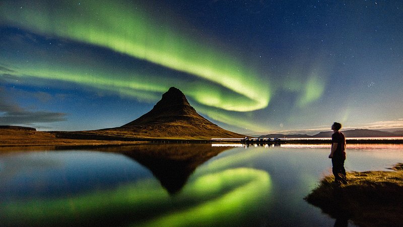 The Aurora Borealis over a snowy landscape in Northern Europe.
